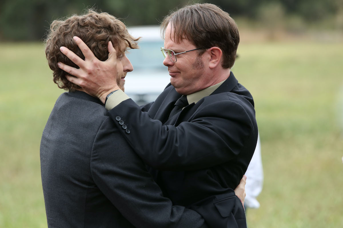 Thomas Middleditch as Jeb Schrute and Rainn Wilson as Dwight Schrute embracing in a scene from 'The Farm'