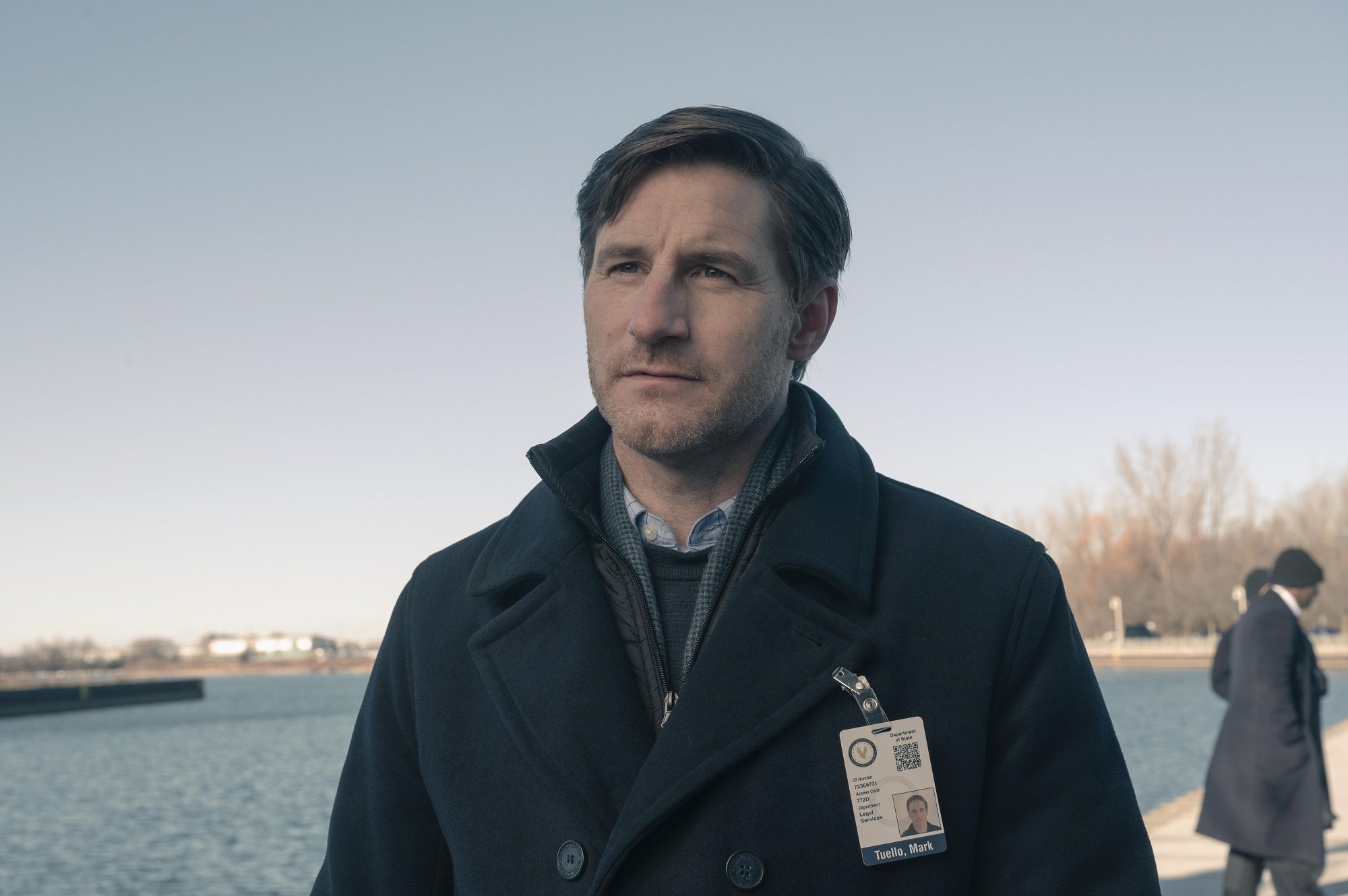 Mark Tuello (Sam Jaeger) stands on a dock in front of water in 'The Handmaid's Tale'