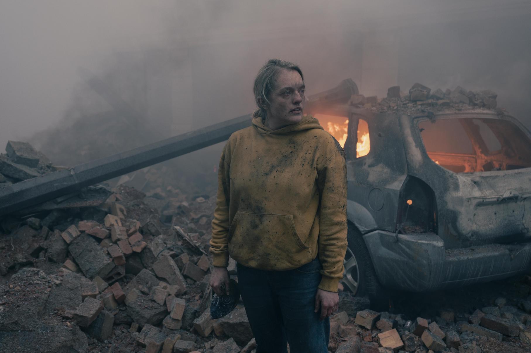 Elisabeth Moss as June Osborne in 'The Handmaid's Tale' Season 4 standing in rubble after a bombing