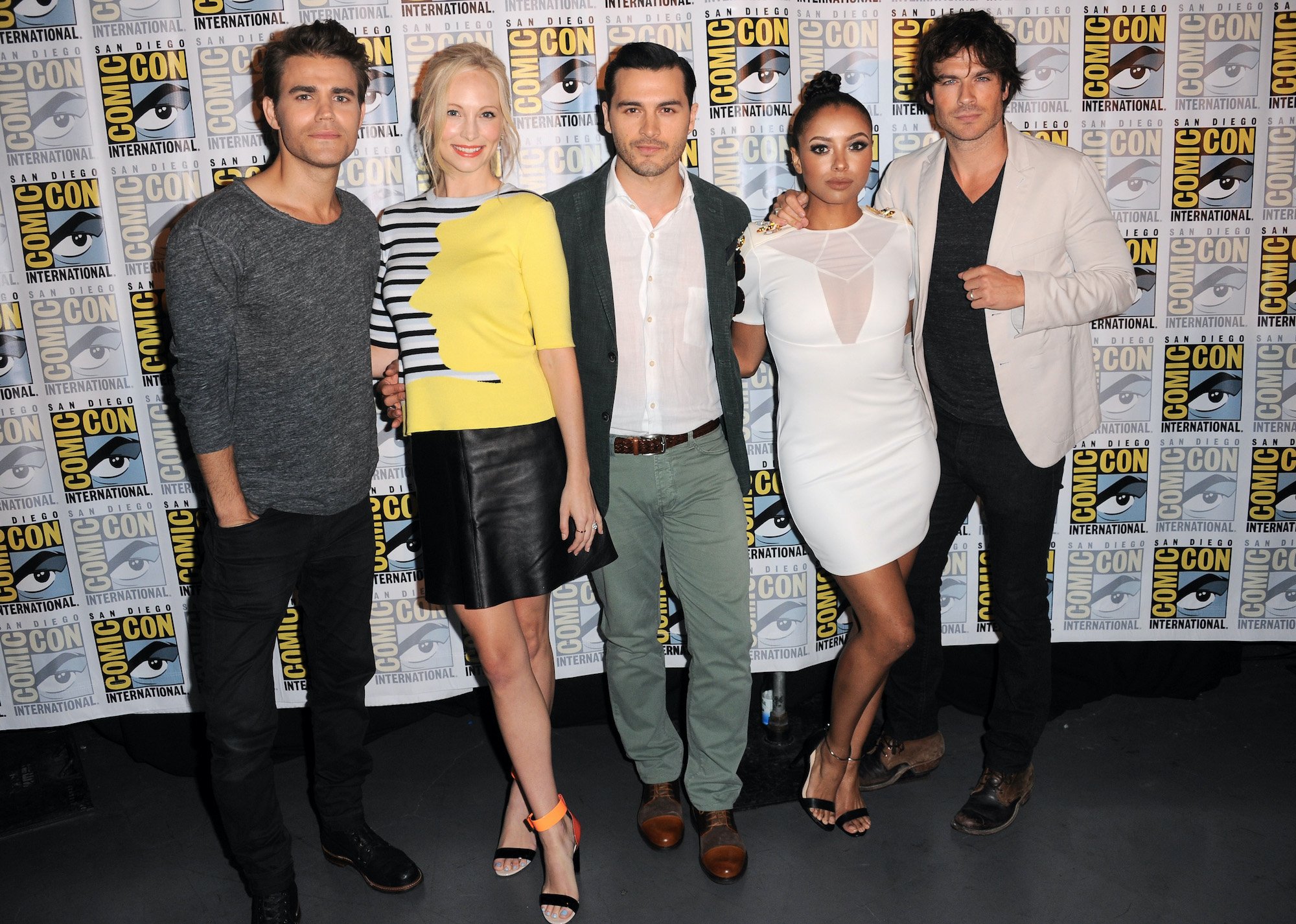 The Vampire Diaries cast in front of a ComicCon backdrop