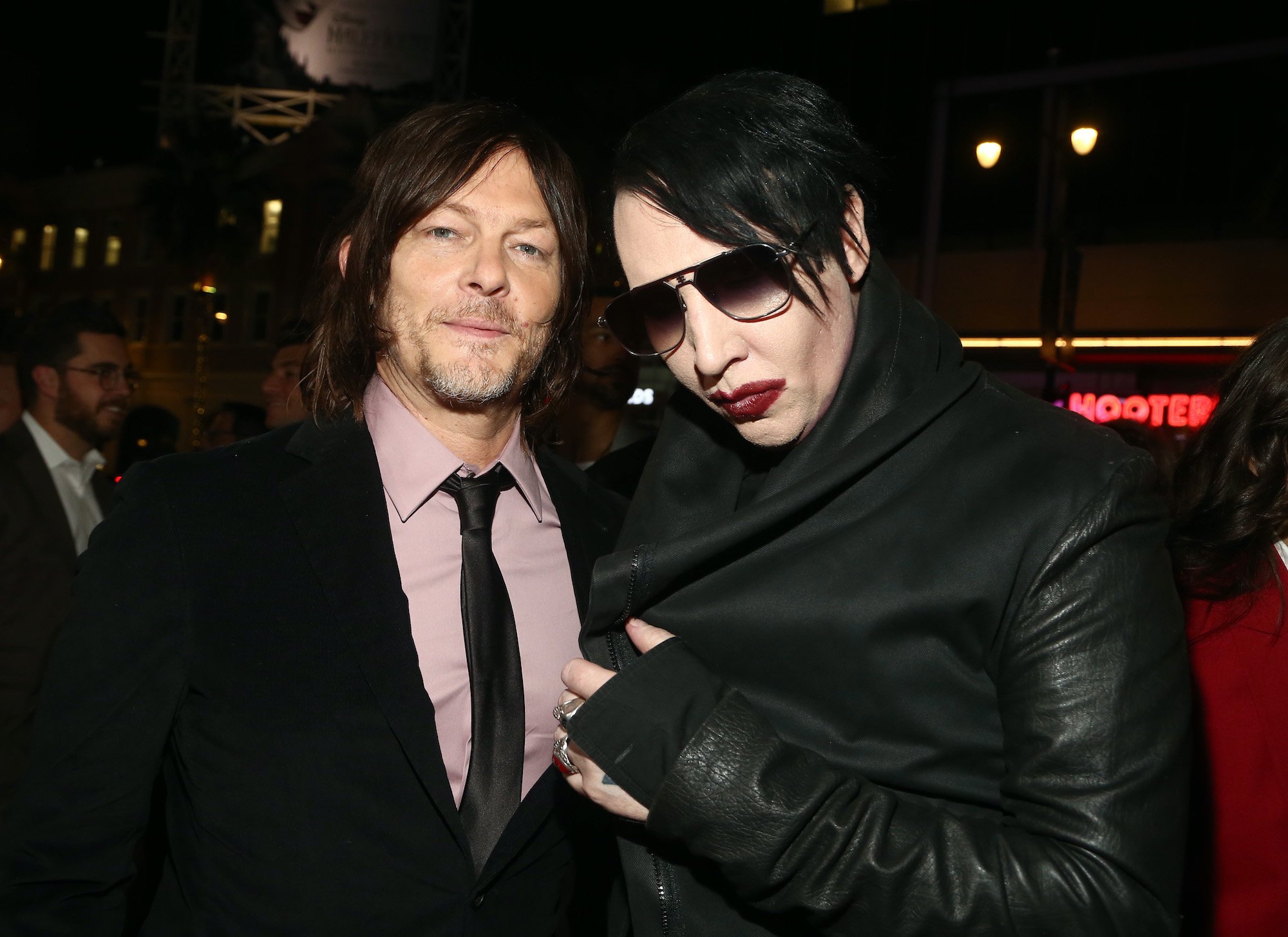 Norman Reedus and Marilyn Manson looking at the camera