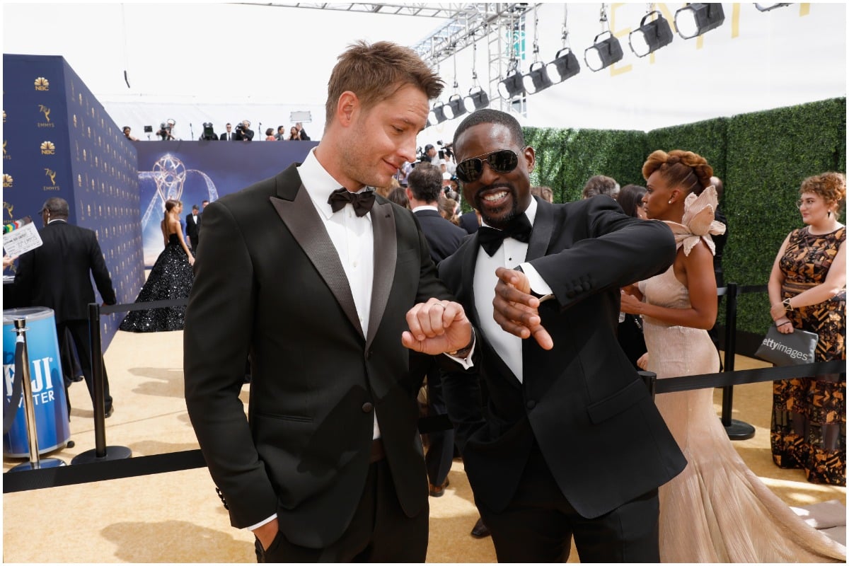 'This Is Us' co-stars Sterling K. Brown and Justin Hartley wearing black and white suits and looking at their watches.