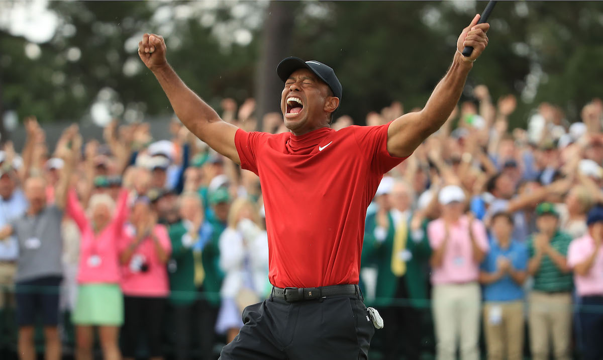 Tiger Woods (L) of the United States celebrates on the 18th green after winning the Masters at Augusta National Golf Club on April 14, 2019 in Augusta, Georgia.
