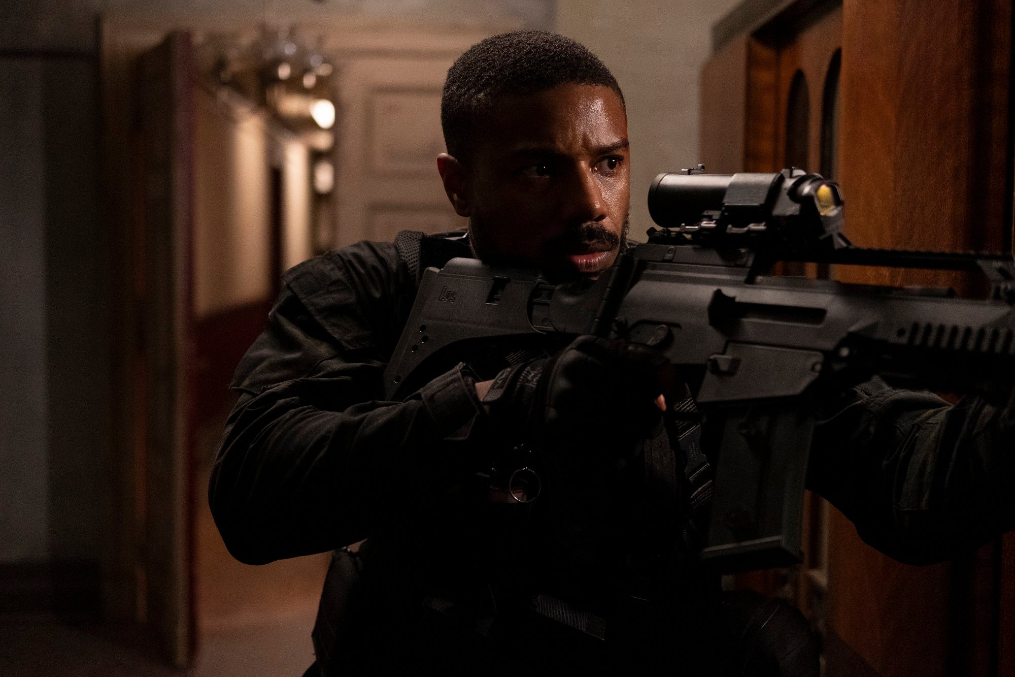 Tom Clancy's Without Remorse: Michael B. Jordan holds a gun