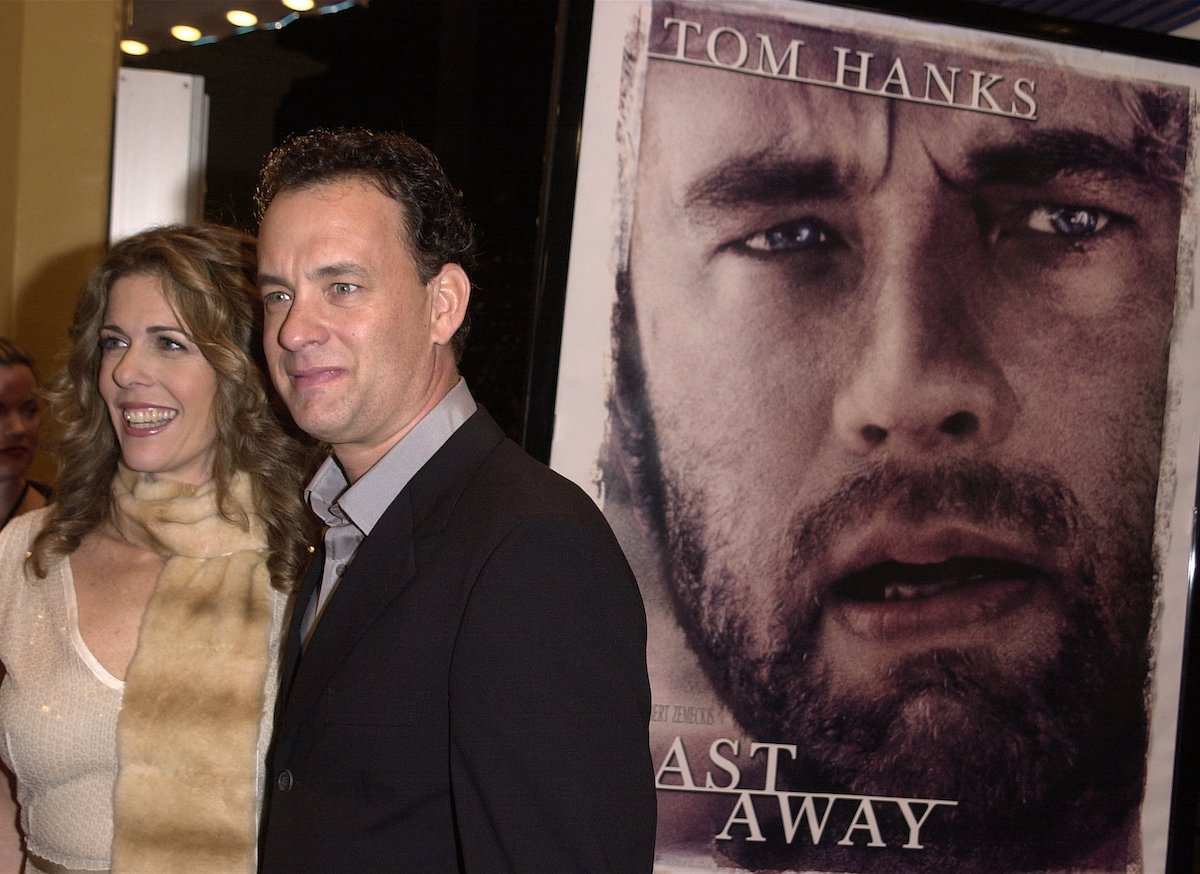 Tom Hanks and Rita Wilson pose in front of a 'Cast Away' poster