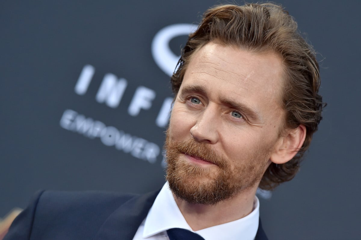 Tom Hiddleston wears a suit and poses at the 'Avengers: Infinity War' premiere