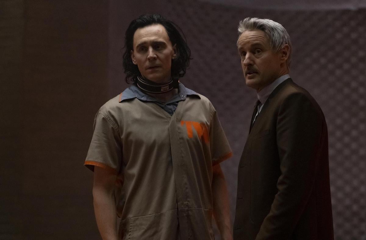 Tom Hiddleston in a beige prison uniform and Owen Wilson in a brown suit in 'Loki'