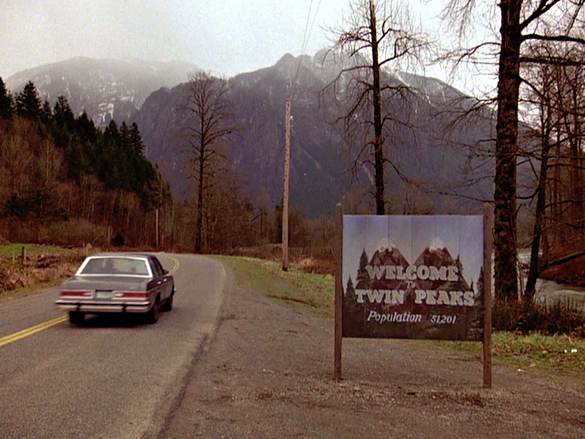 'Twin Peaks' welcome sign in front of a giant mountain