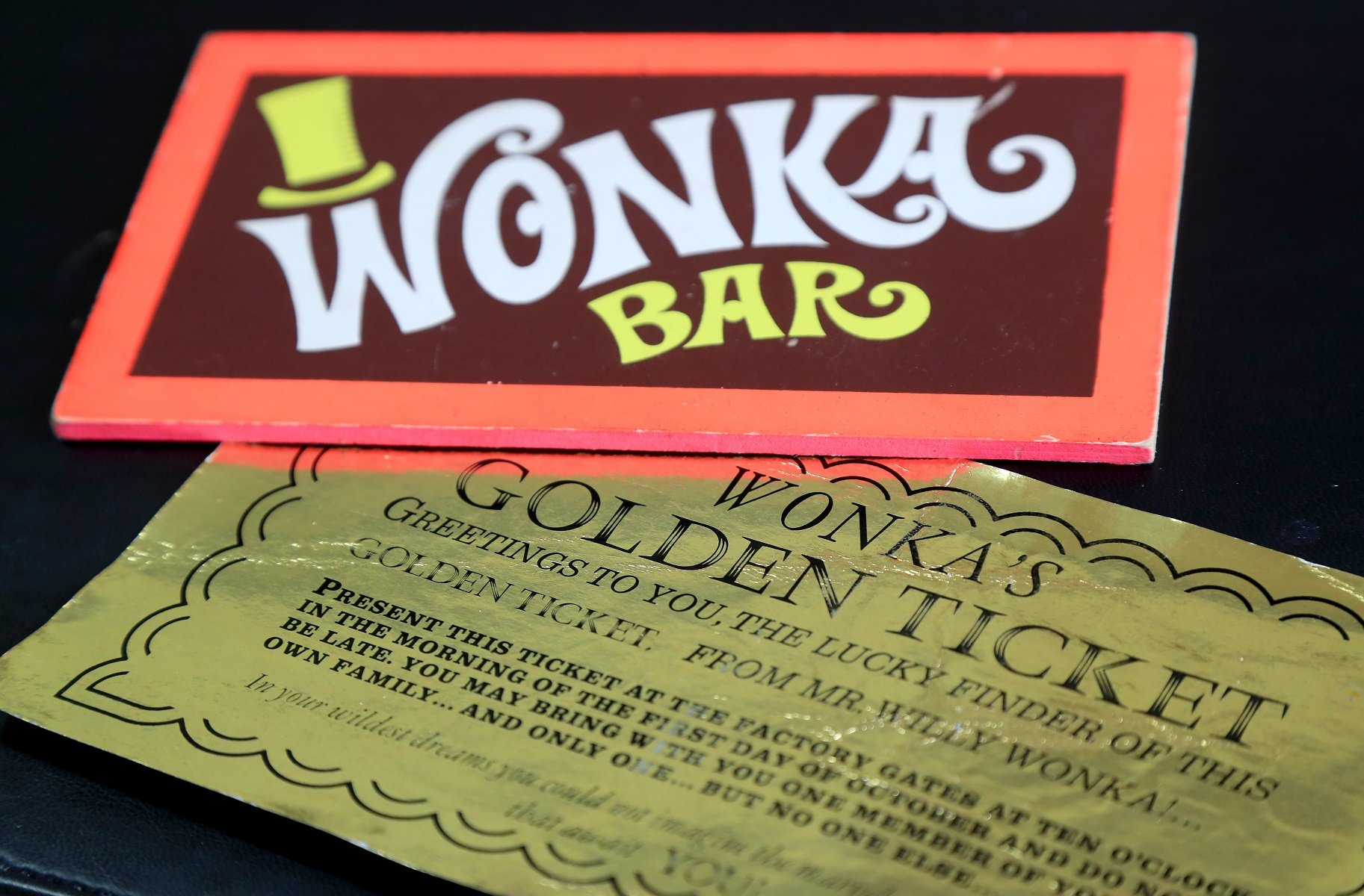 A Wonka Bar and a golden ticket from the 1971 movie, 'Willy Wonka & The Chocolate Factory' is photographed before being aucitoned off