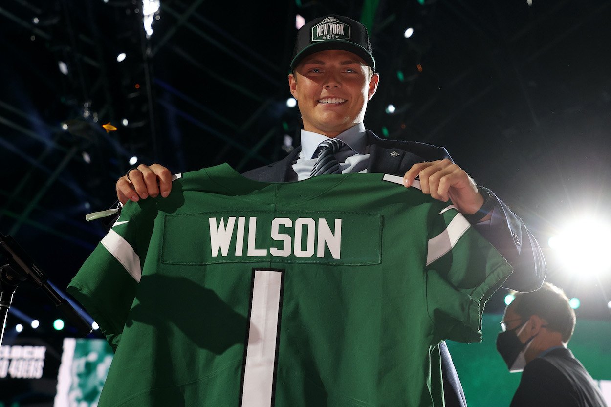 Zach Wilson holds a Jets jersey onstage after being drafted second at the 2021 NFL draft