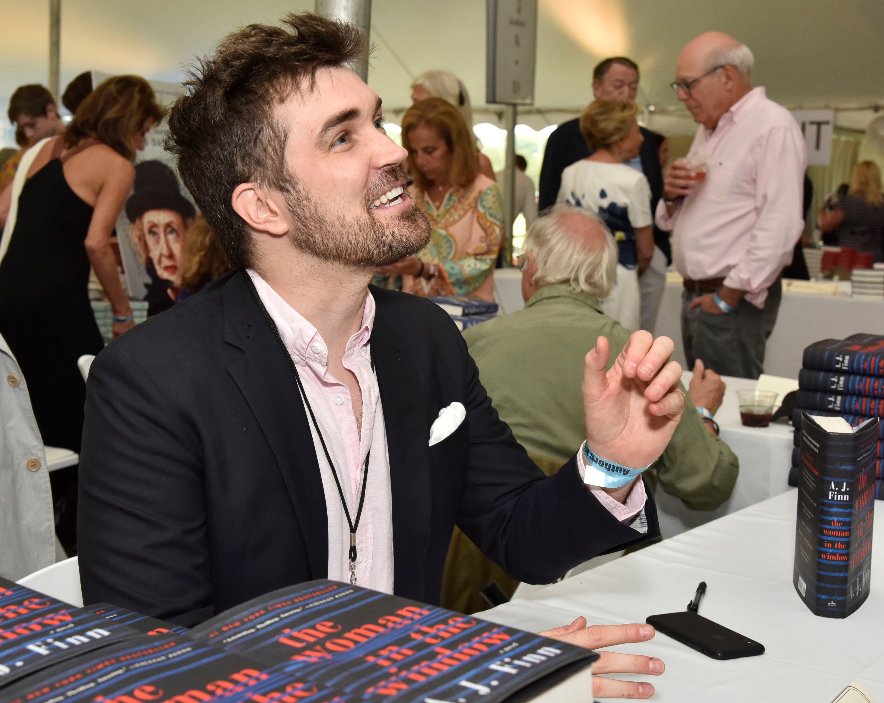 AJ Finn/Dan Mallory signs copies of the Woman in the Window at an event