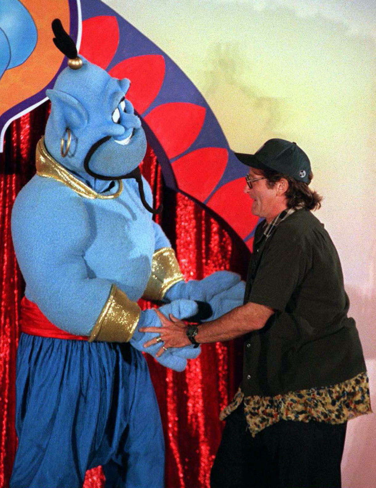 Actor-comedian Robin Williams dances 10 July in Los Angeles with the Disney character "Genie" during a celebration for the scheduled 13 August world release of the film 'Aladdin'