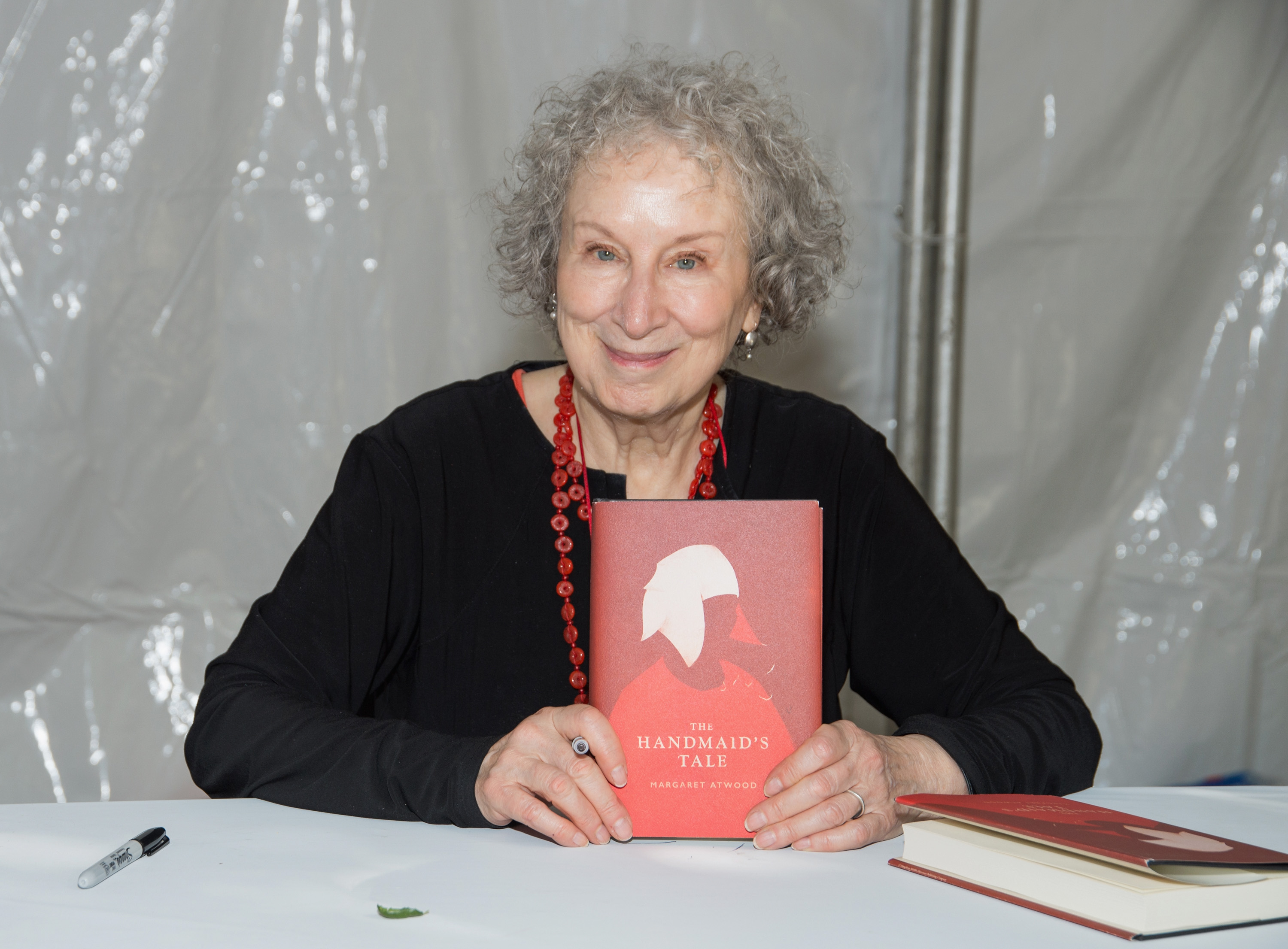 Author Margaret Atwood with a copy of The Handmaid's Tale