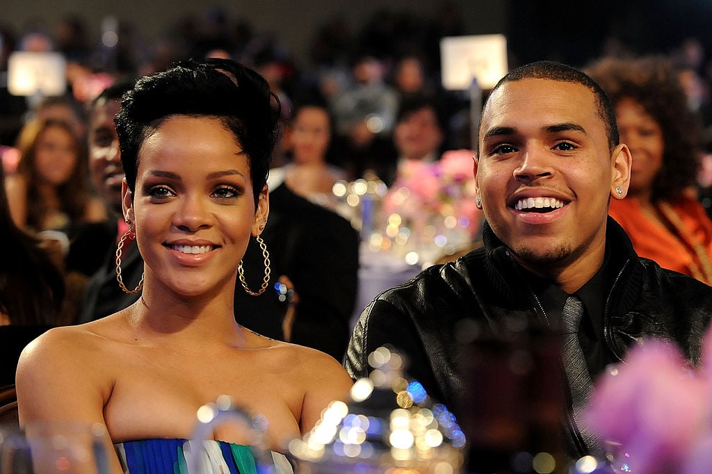 Rihanna and Chris Brown at a table