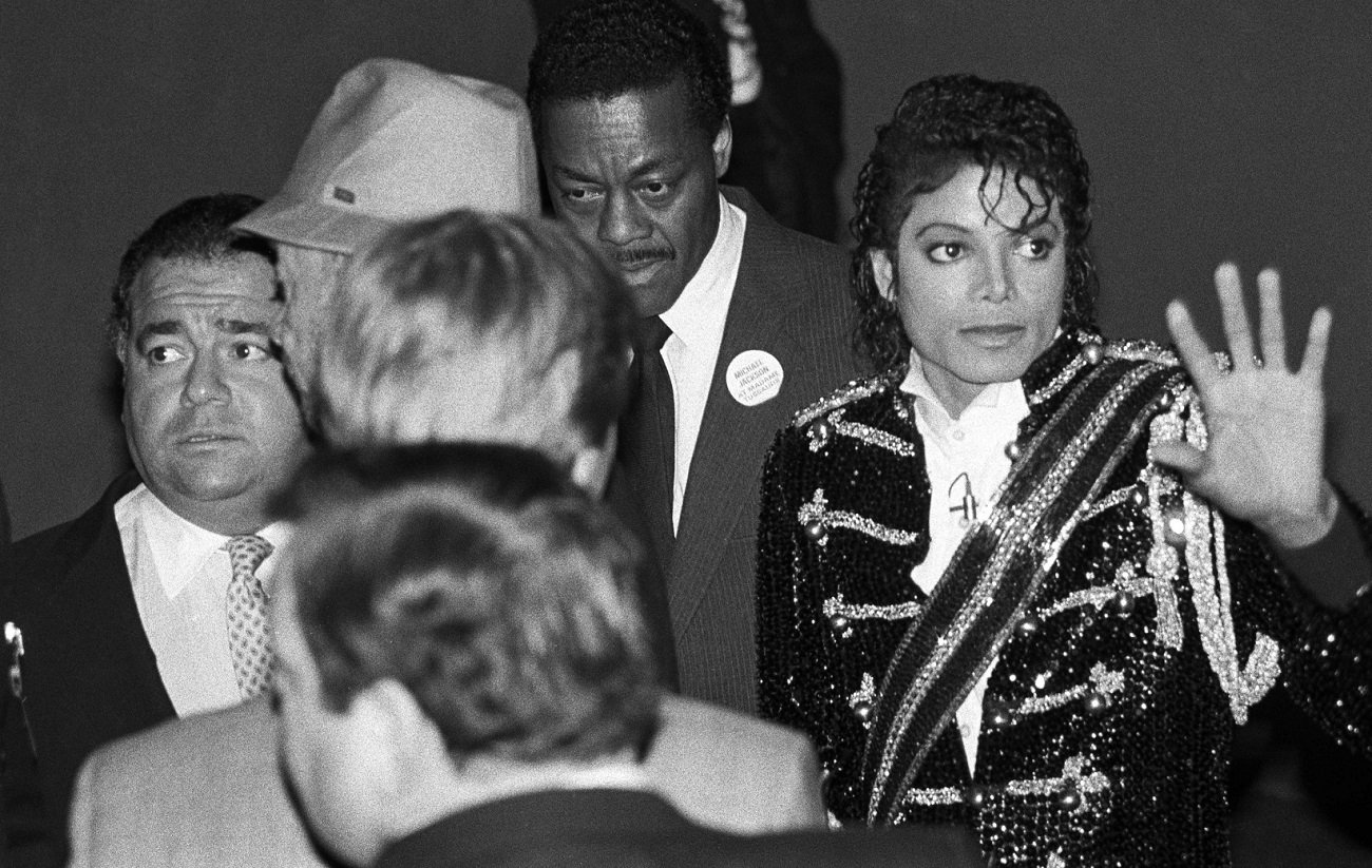 Frank DiLeo looks off-camera as Michael Jackson waves to fans