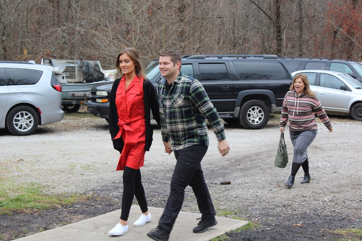 Esther Keyes and Nathan Bates holding hands and walking in episode of Bringing Up Bates