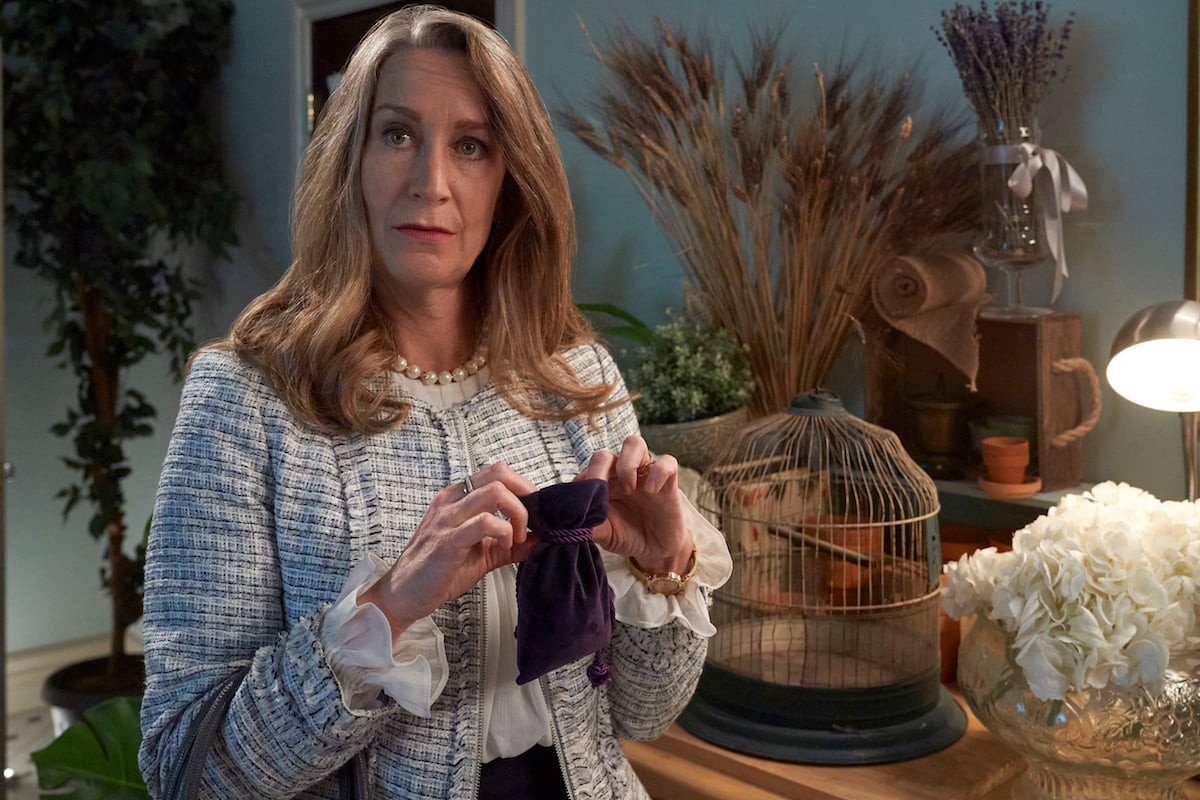 Blond woman holding purple velvet bag in Good Witch season 7 premiere