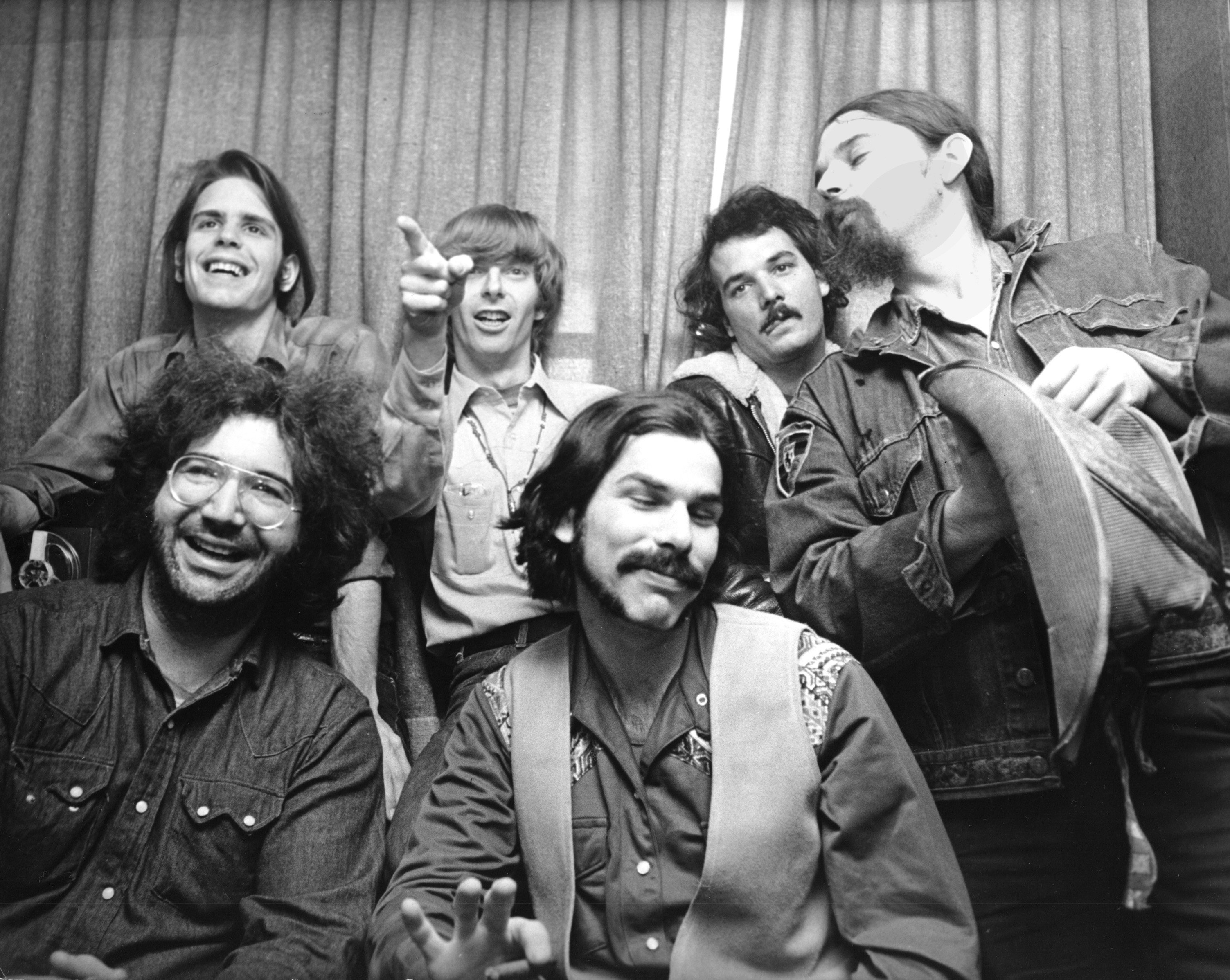 The Grateful Dead in front of a curtain