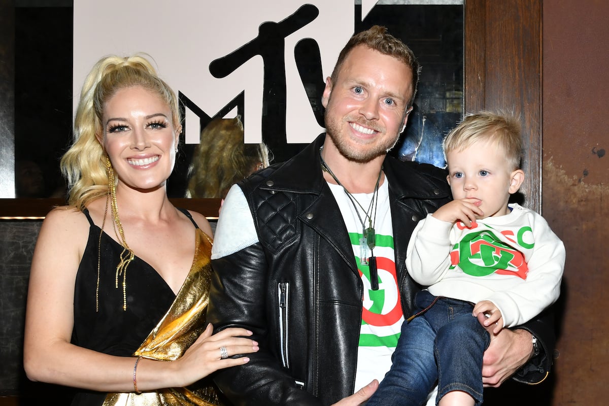 Heidi Montag, wearing black sleeveless top, with Spencer Pratt, who is holding their son Gunner