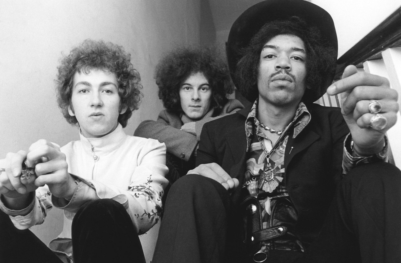 The Jimi Hendrix Experience, seated, looks directly in the camera, 1967