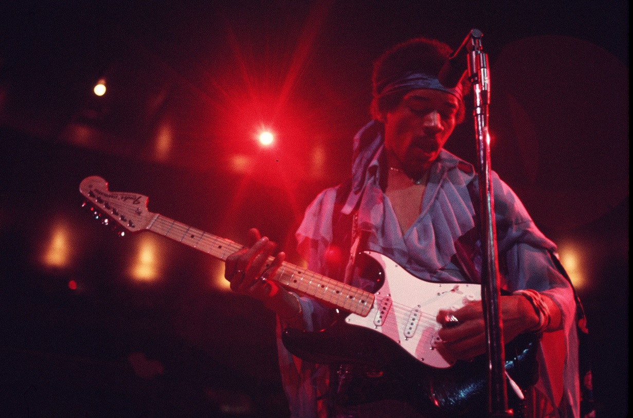 Jimi Hendrix playing guitar on stage in 1969