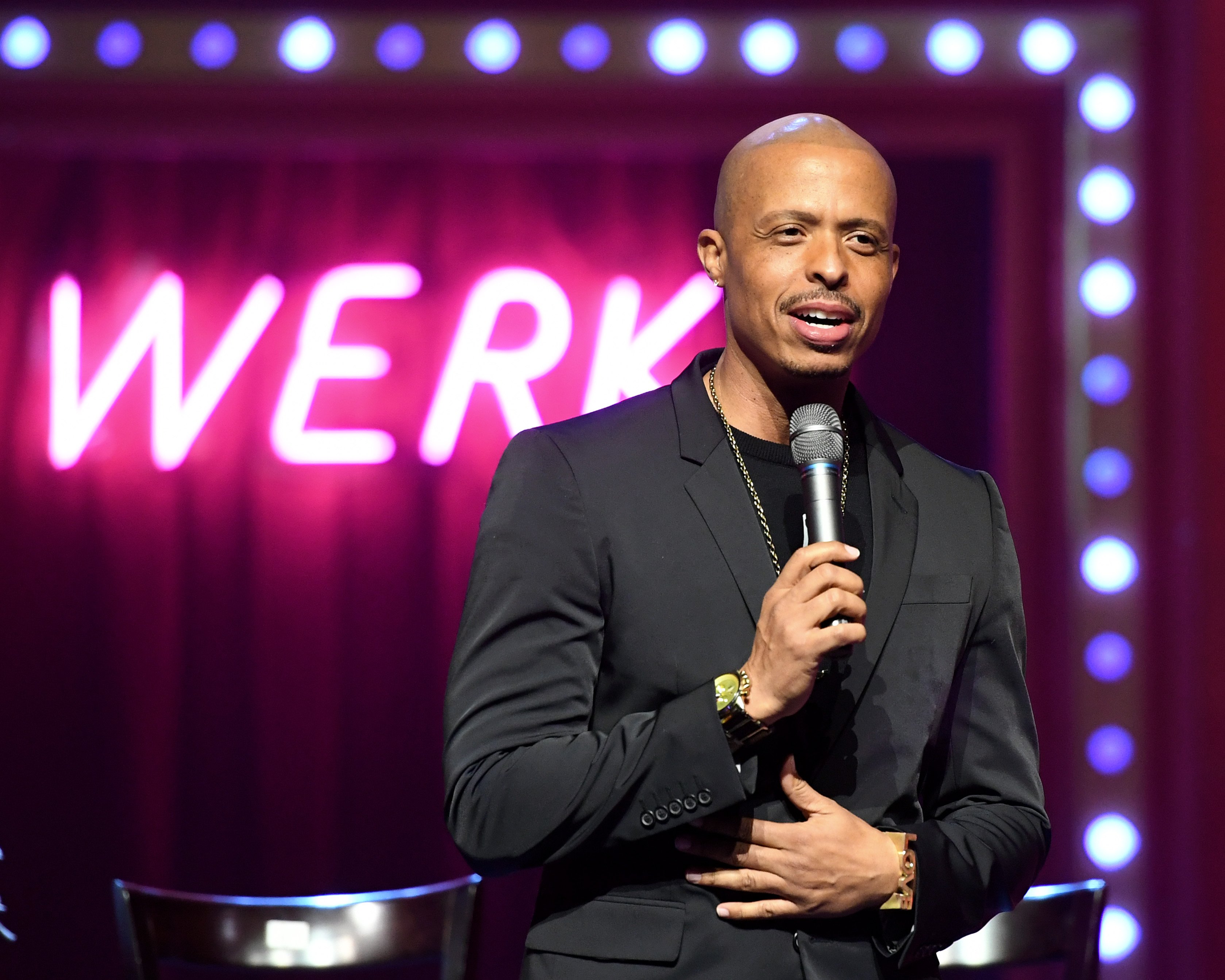 Jamal Sims holding a microphone at RuPaul's Drag Race Live! 