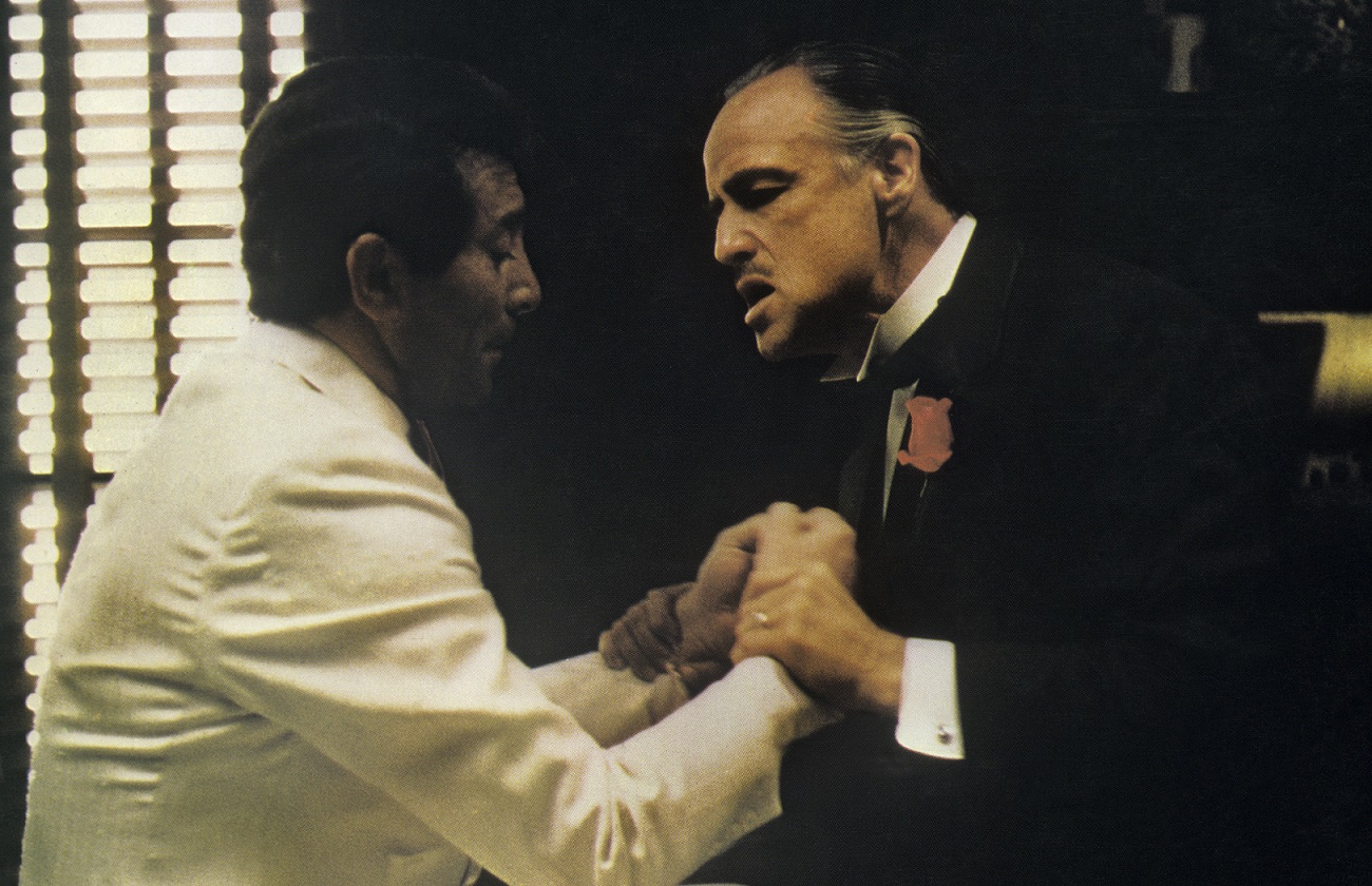 Marlon Brando holds Al Martino by the wrists and speaks in a scene from 'The Godfather'