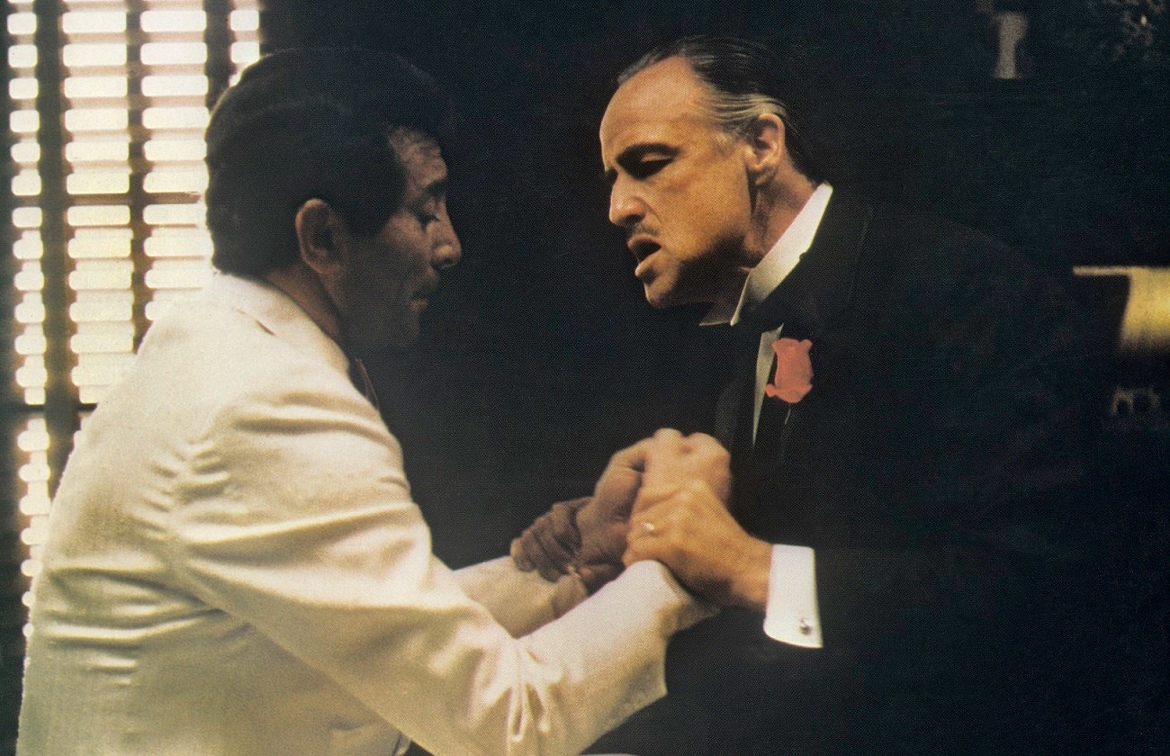 Marlon Brando holds Al Martino by the wrists and speaks in a scene from 'The Godfather'
