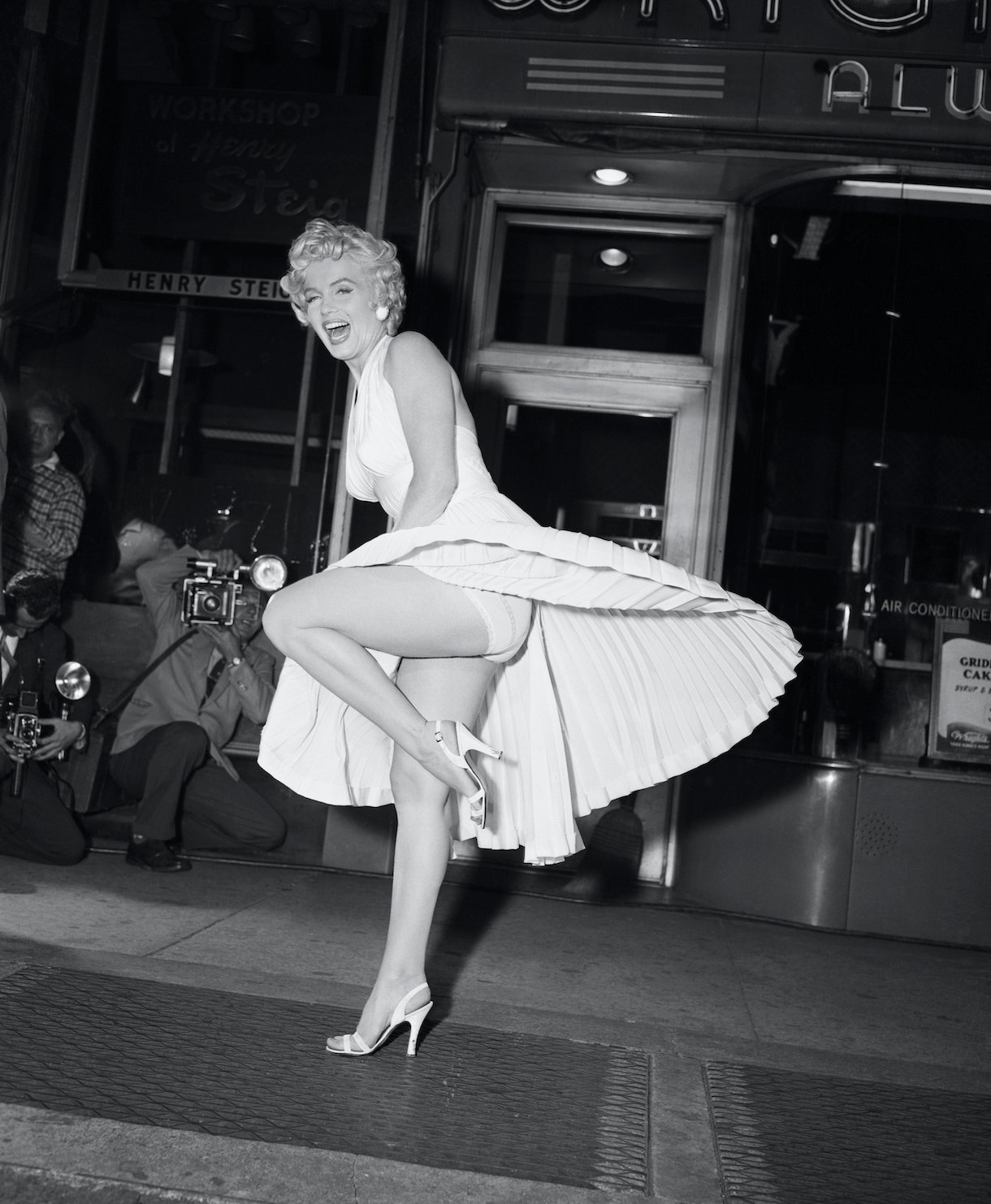 Film star Marilyn Monroe poses over a Manhattan subway grate as the wind blows her white dress up