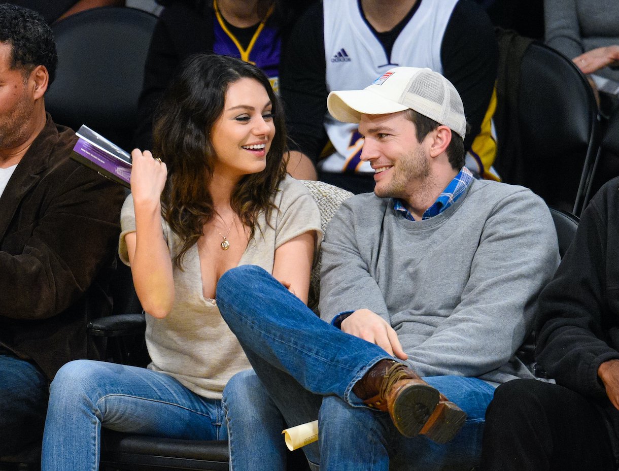 Mila Kunis (L) and Ashton Kutcher attend a basketball game between the Oklahoma City Thunder and the Los Angeles Lakers in 2014
