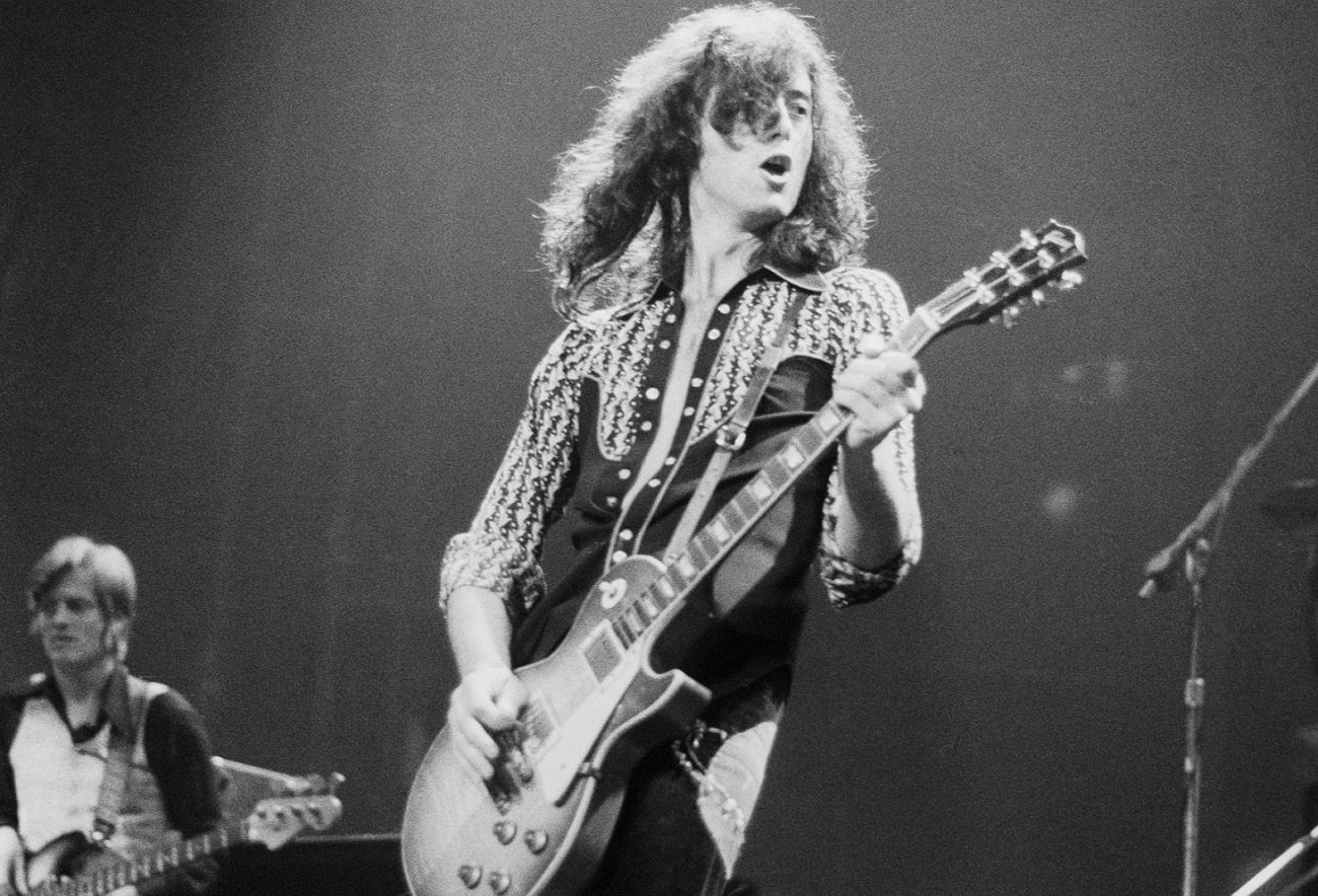 Jimmy Page plays guitar on stage with Led Zeppelin
