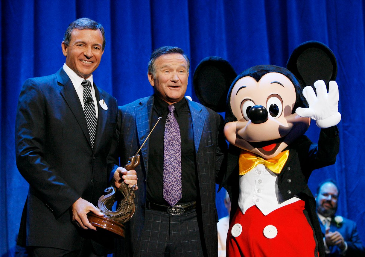 In this handout image provided by Disney, actor Robin Williams (C) is recognized by Bob Iger, CEO of Walt Disney Co.,and Mickey Mouse for Williams' work in "Aladdin,"
