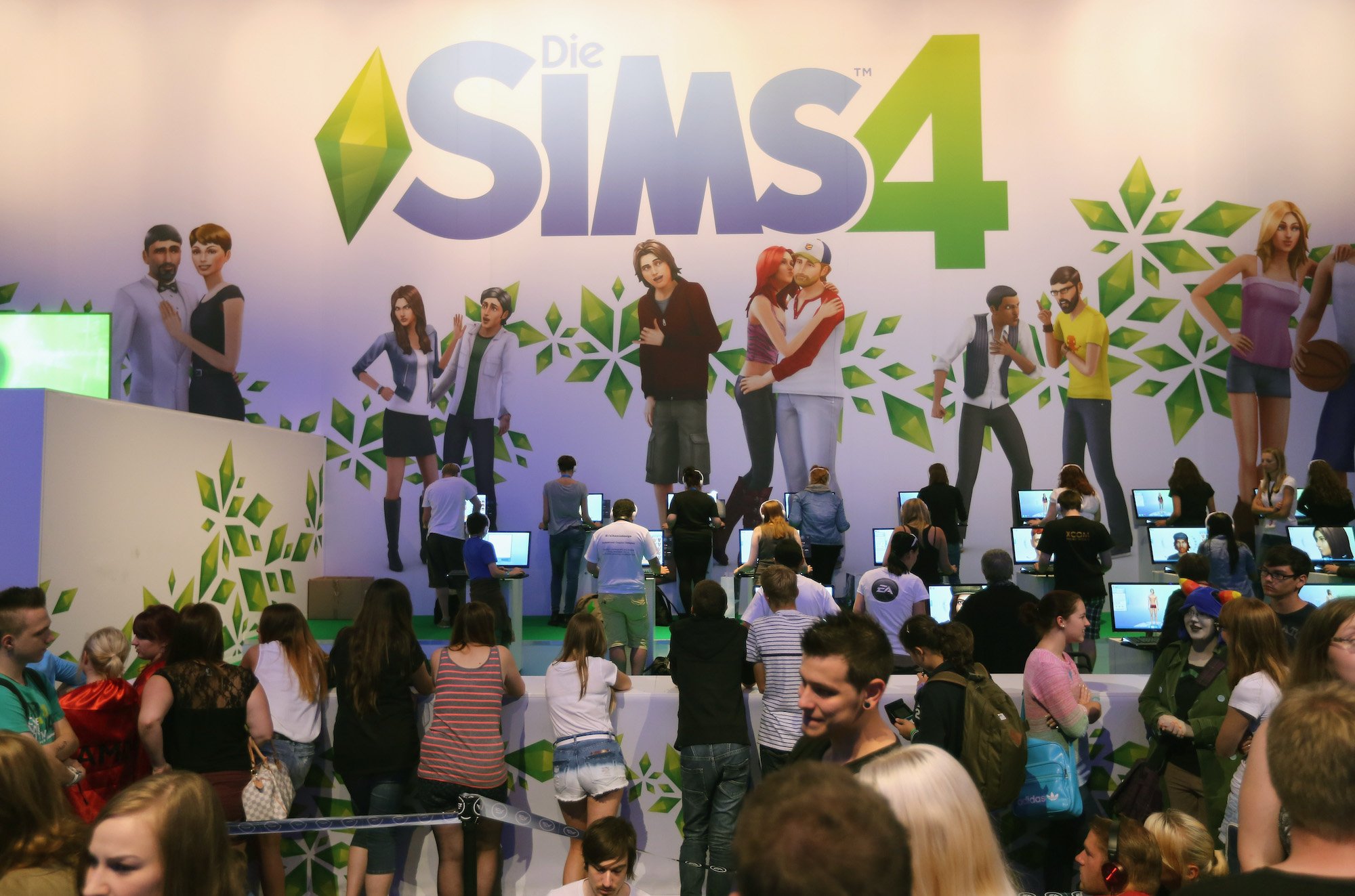 Gaming enthusiasts try out the 'The Sims 4' game on the new XBOX at the Gamescom 2013 gaming trade air on August 22, 2013