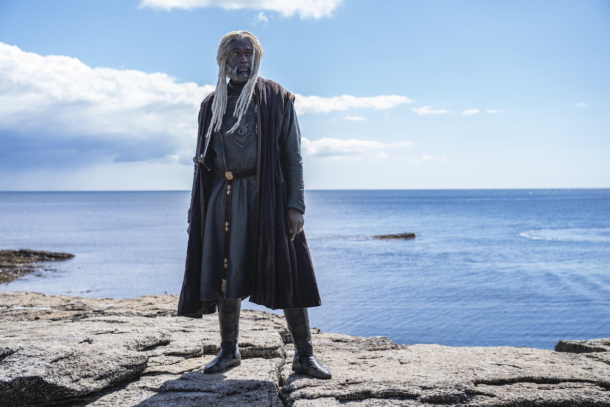 Steve Toussaint as Lord Corlys Velaryon "The Sea Snake" stands by a large body of water in 'House of the Drago'