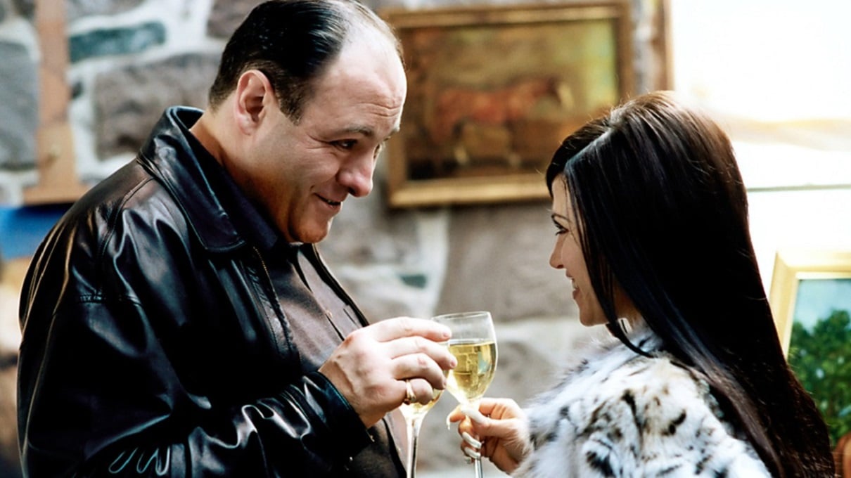 James Gandolfini and Leslie Bega clink their glasses in a toast in a scene from 'The Sopranos.'