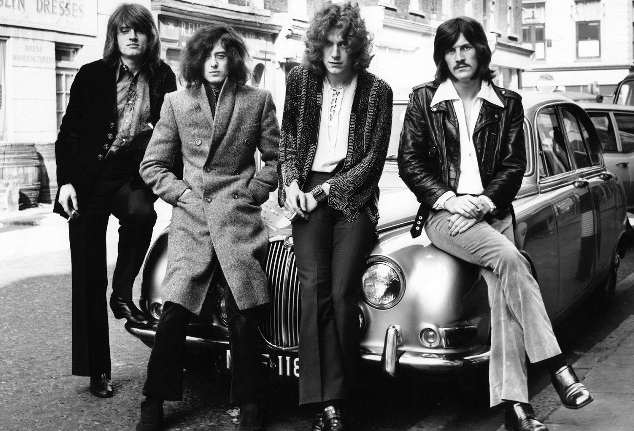Led Zeppelin poses seated on car bonnet during their first photo shoot, December 1968.