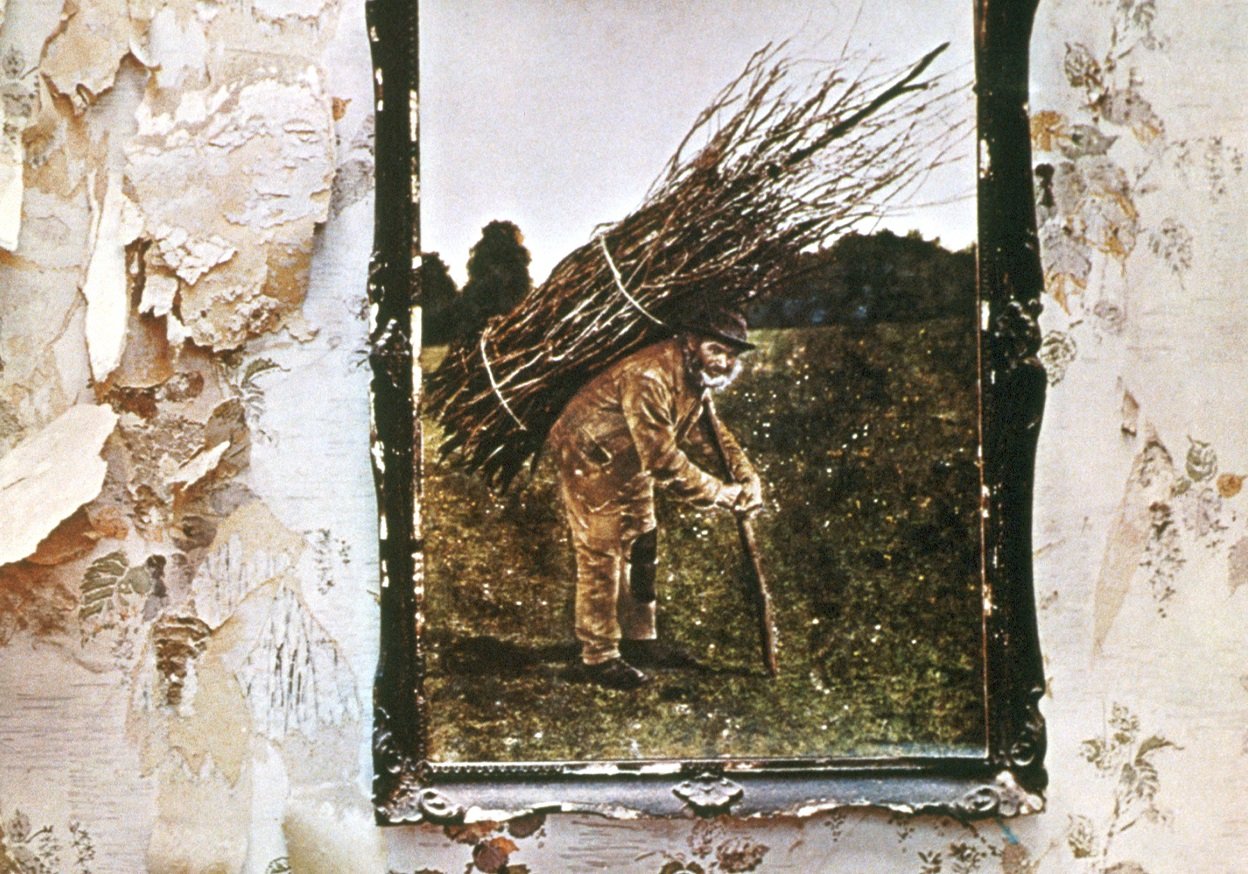 Detail of 'Led Zeppelin IV' album cover featuring an old man carrying a bundle of wood on his back