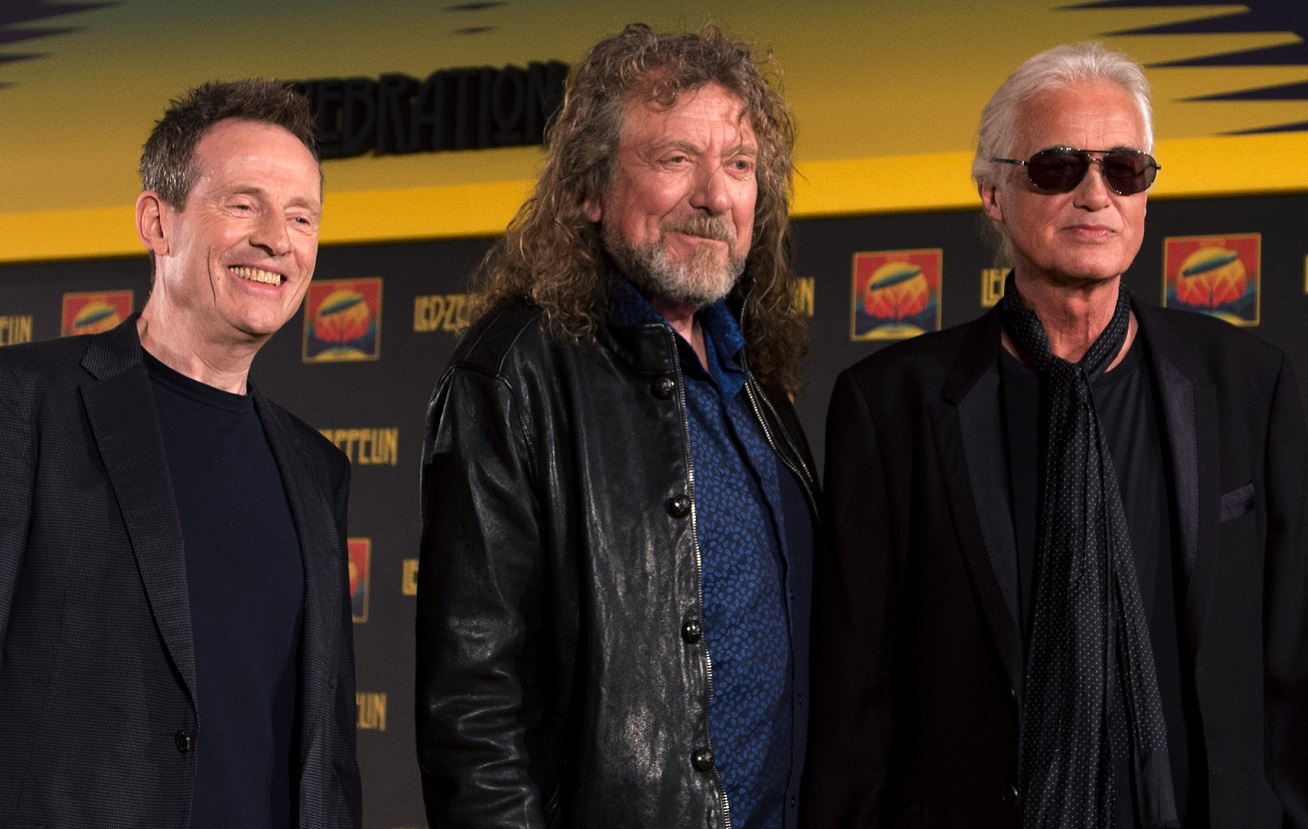John Paul Jones, Robert Plant, and Jimmy Page smile and pose together in 2012.