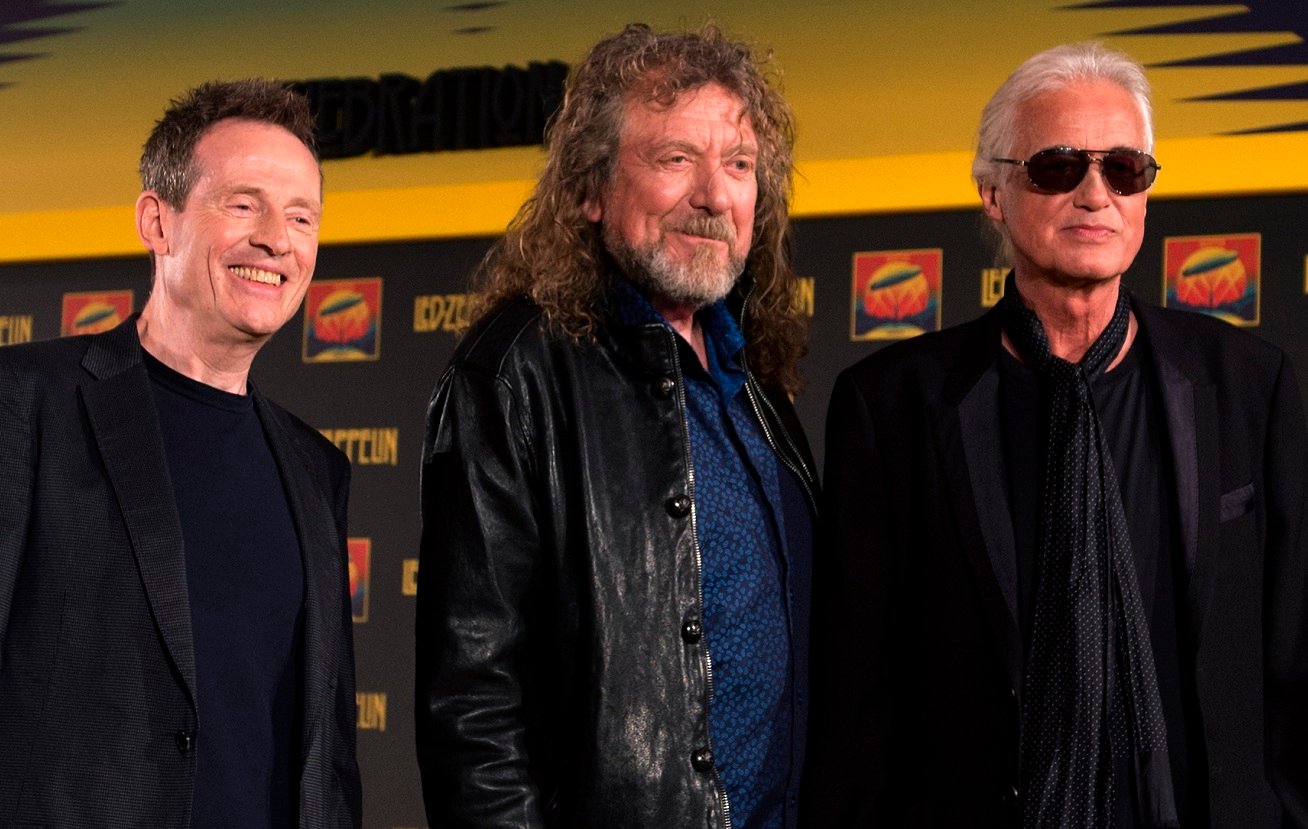 John Paul Jones, Robert Plant, and Jimmy Page smile and pose together in 2012.