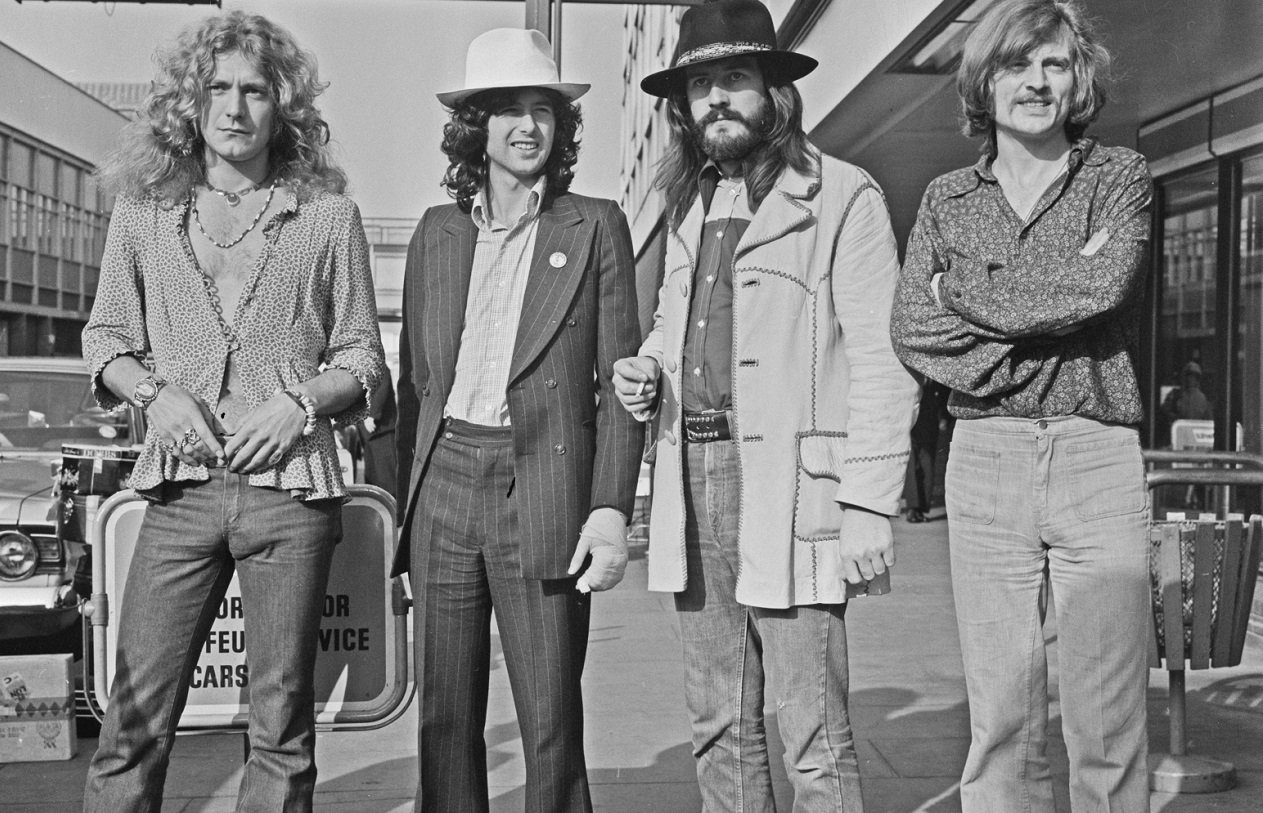 Led Zeppelin posing for camera at Heathrow in 1973