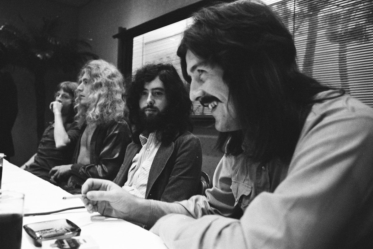 John Bonham laughs as Led Zeppelin band members look on during a press conference