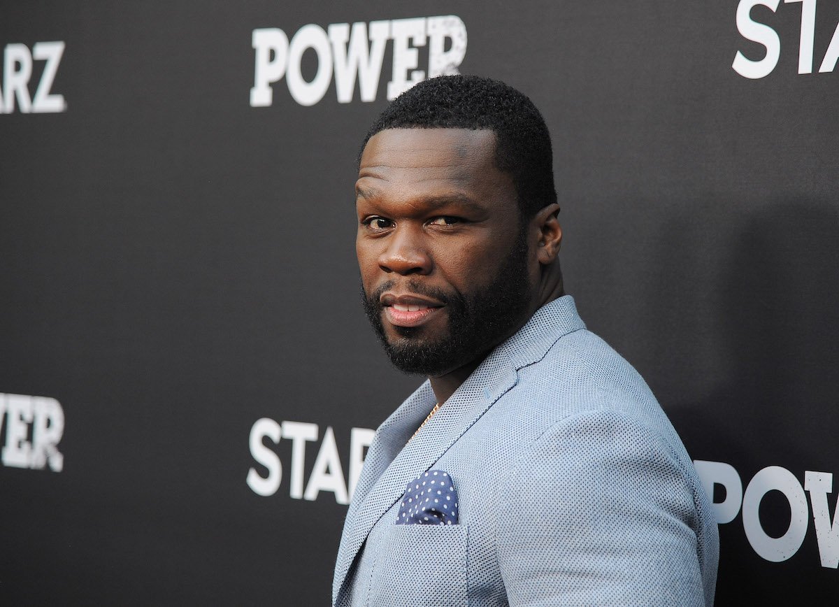 50 Cent wearing a grey suit