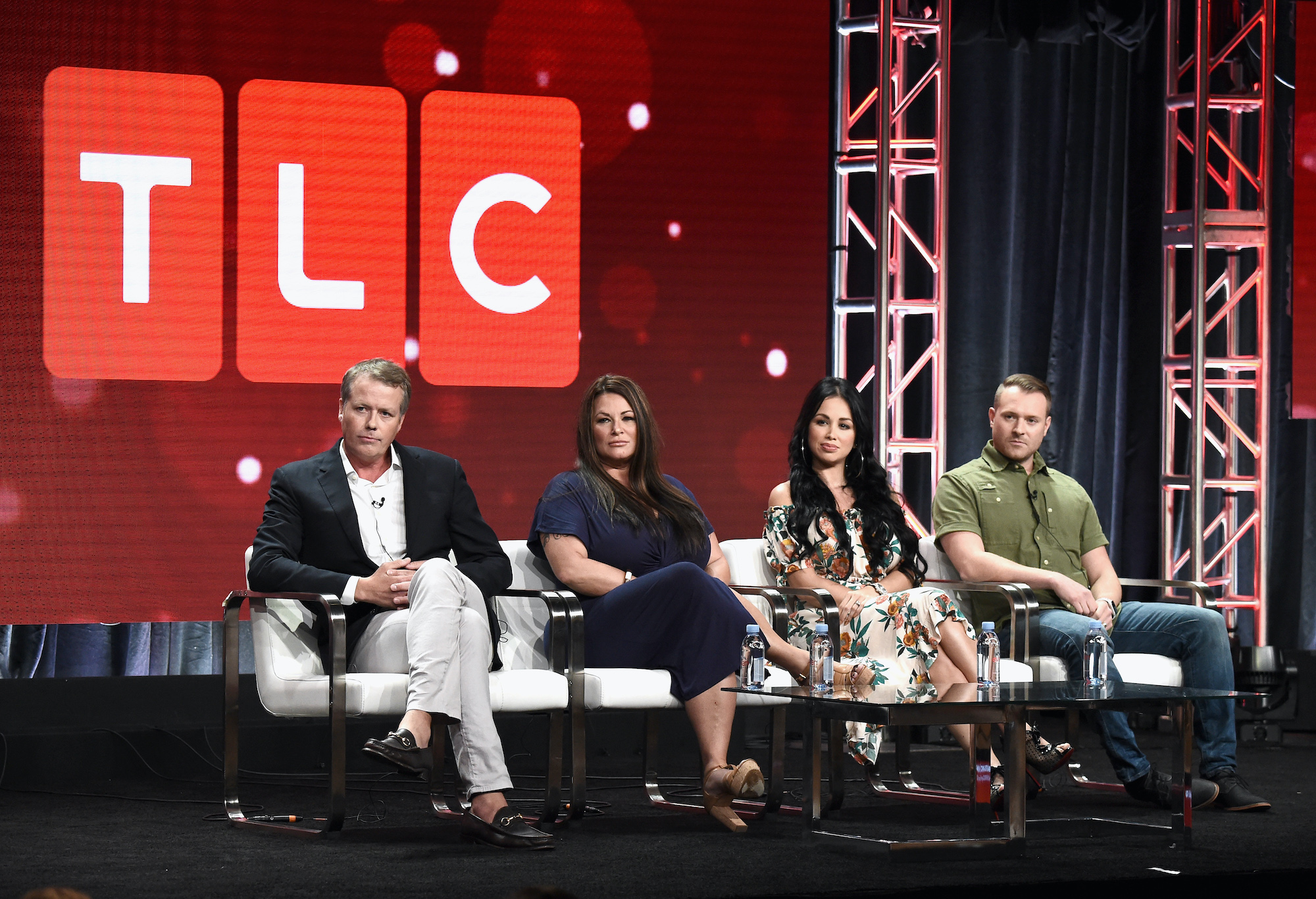 TLC executives discuss '90 Day Fiance' in front of a TLC logo