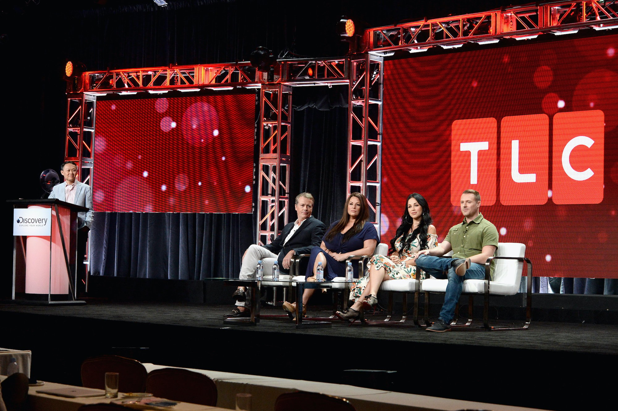 TLC executives gathered on stage at a conference