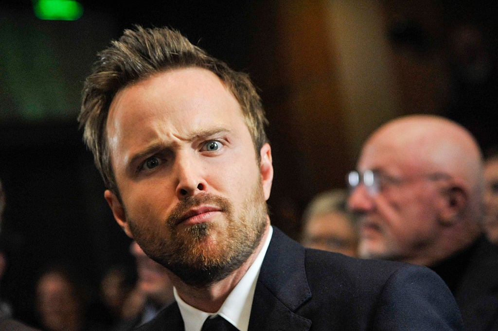 'Breaking Bad' star Aaron Paul walks a red carpet with a funny look on his face.
