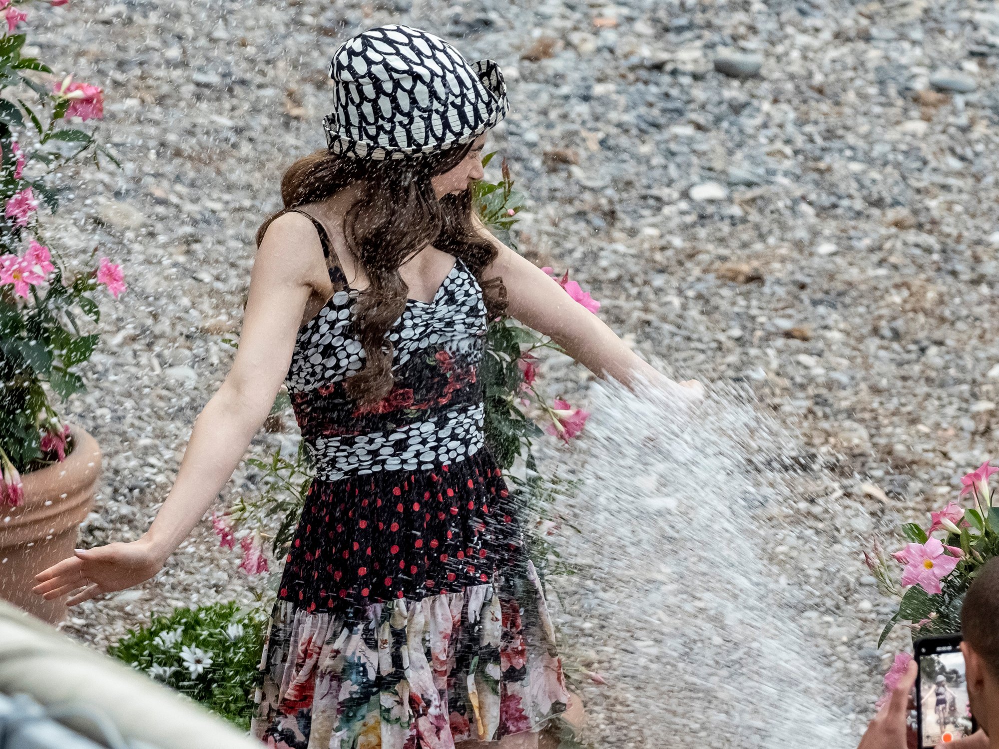Actress Lily Collins gets sprayed with water on the set of Emily in Paris in Saint-Jean-Cap-Ferrat, France.