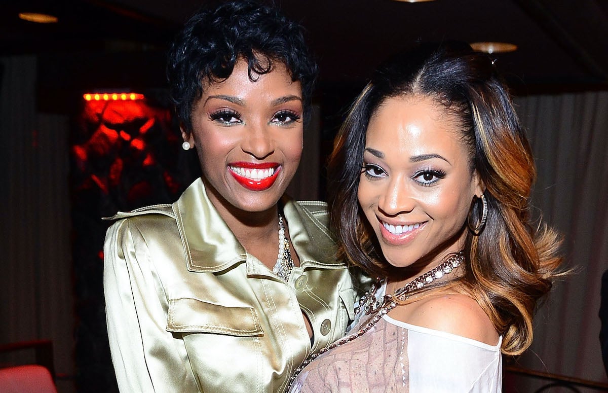 Ariane Davis and Mimi Faust hug as they pose for a photo at an event together