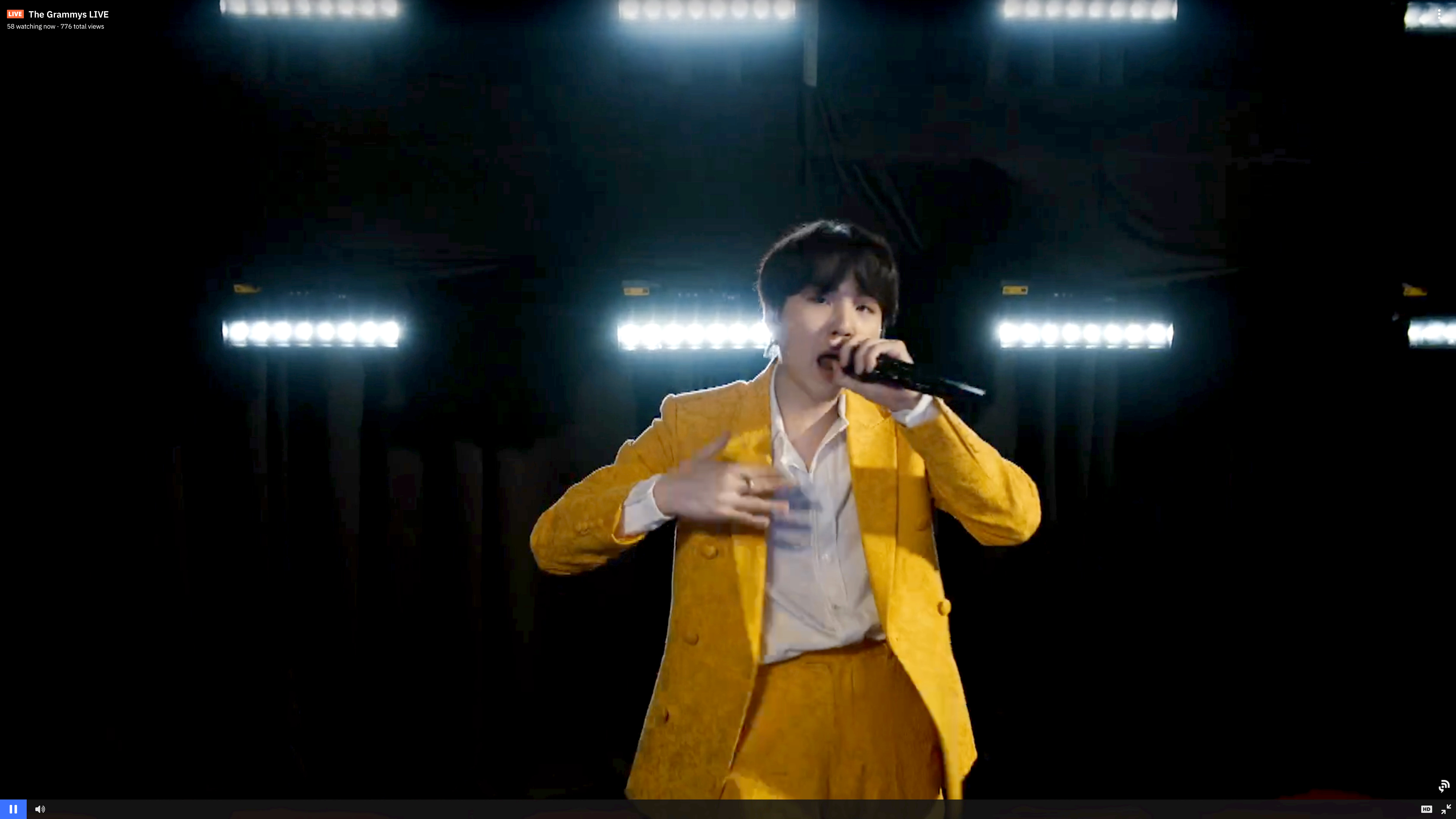 Suga of BTS performs on stage during the 63rd Annual GRAMMY Awards dressed in a yellow suit