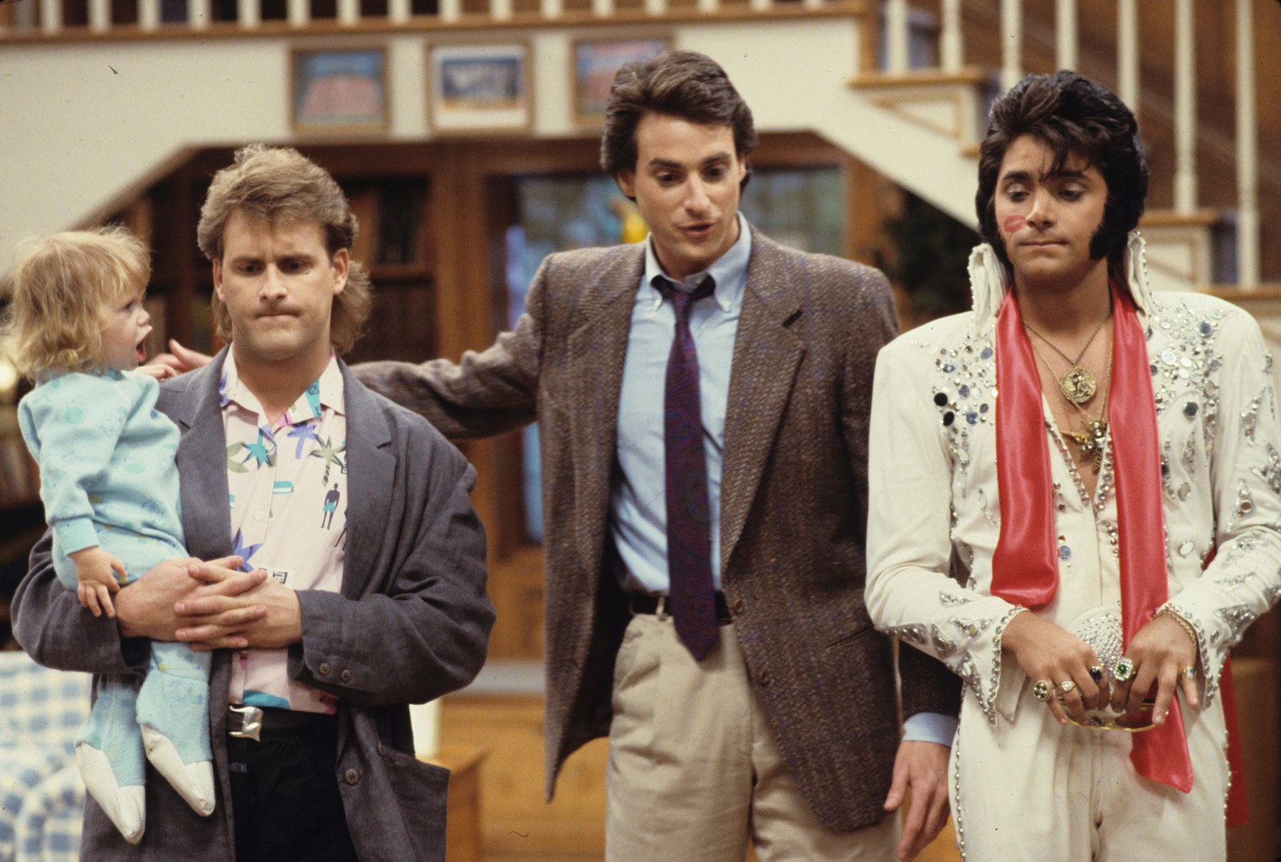 Bob Saget in the 'Full House' episode, 'Mad Money,' dressed in a suit next to the characters Joey Gladstone and Uncle Jesse
