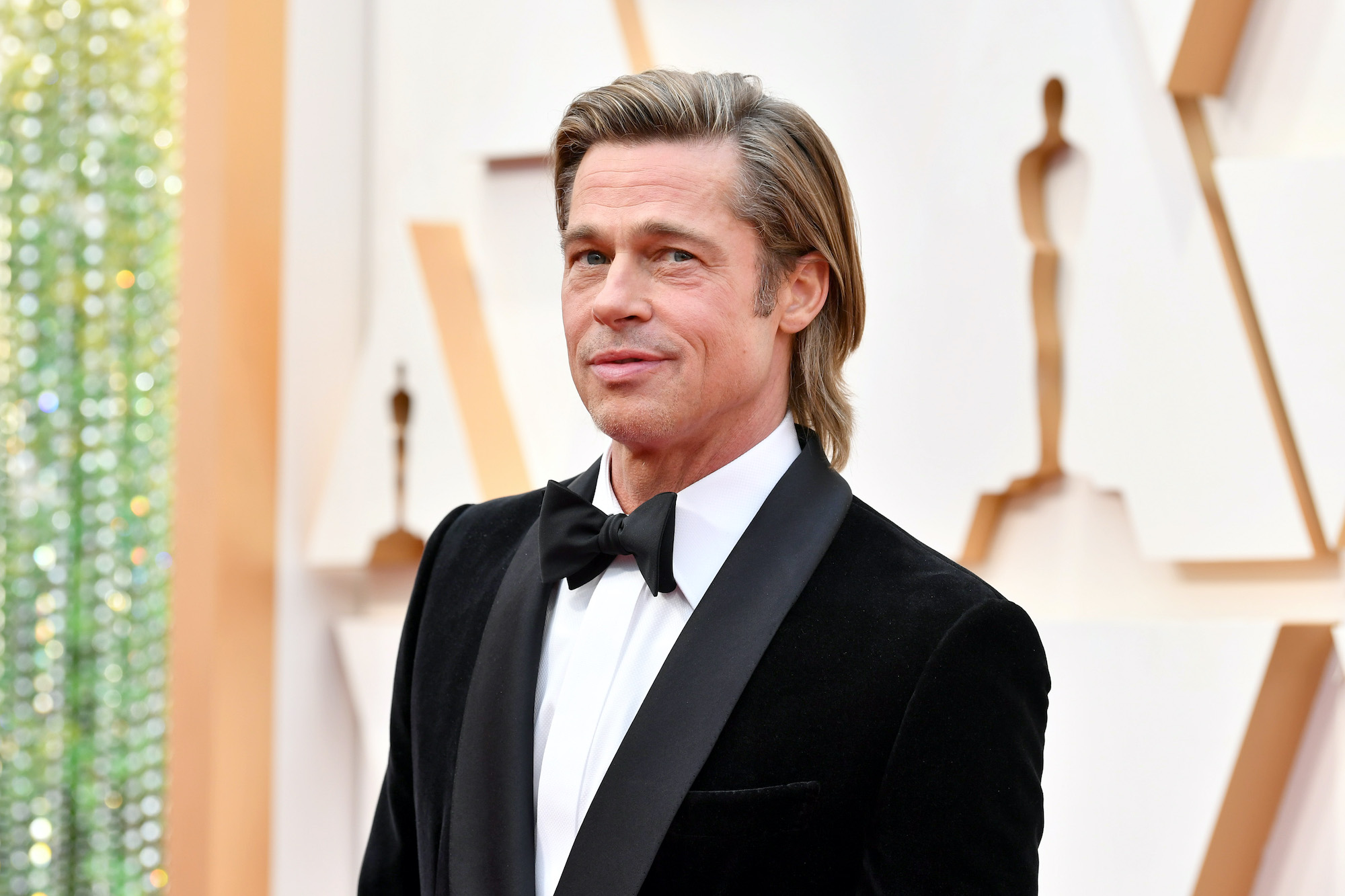 Brad Pitt smiling, turned slightly to the side